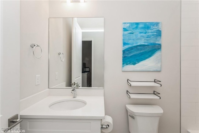 full bathroom with toilet and vanity
