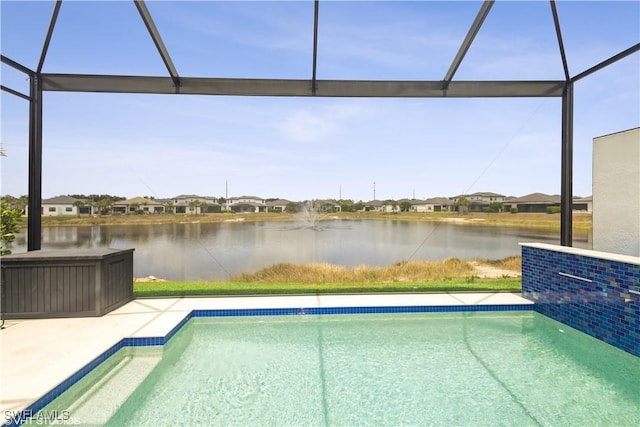 outdoor pool featuring a water view and glass enclosure