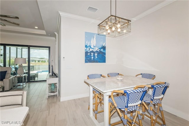 dining area featuring a chandelier, crown molding, baseboards, and recessed lighting
