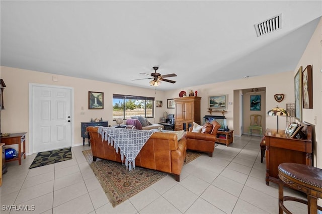 living area featuring a ceiling fan and light tile patterned floors