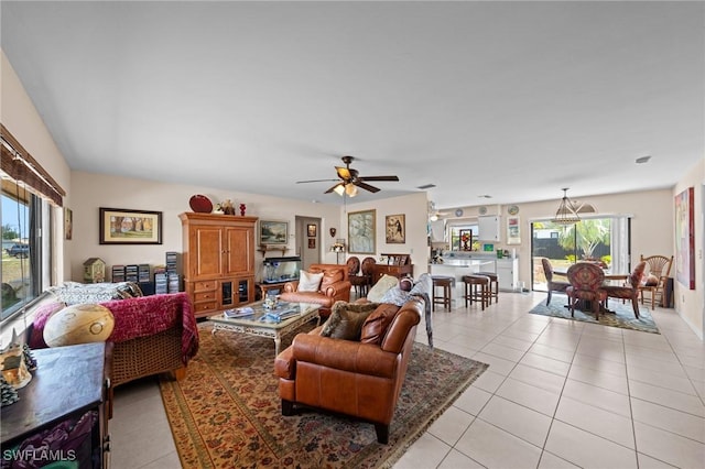living area featuring light tile patterned floors and a ceiling fan