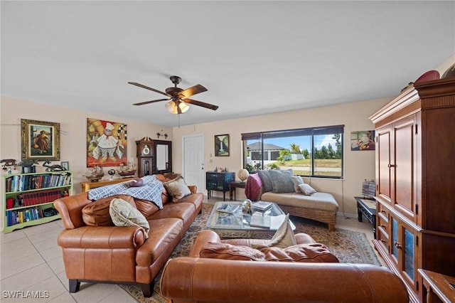 living room with a ceiling fan and light tile patterned flooring