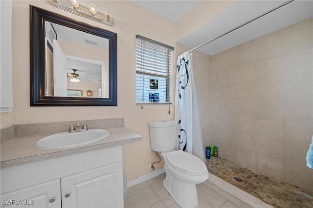 full bathroom featuring tiled shower, toilet, vanity, tile patterned floors, and baseboards