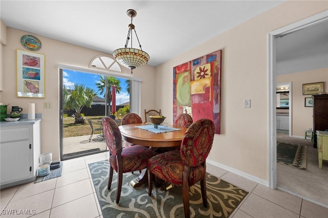 dining area with light tile patterned floors and baseboards