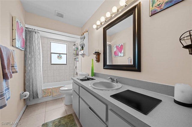 full bathroom featuring toilet, tile patterned flooring, vanity, baseboards, and shower / bath combo