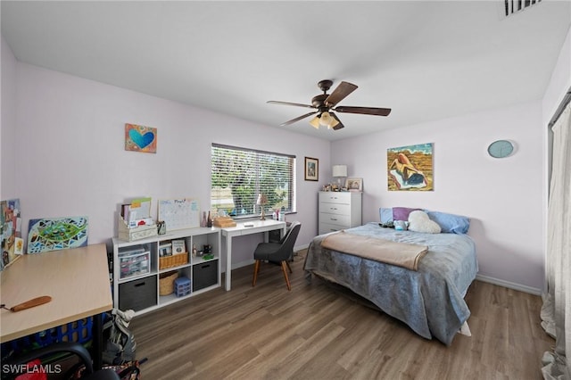 bedroom featuring wood finished floors, ceiling fan, and baseboards