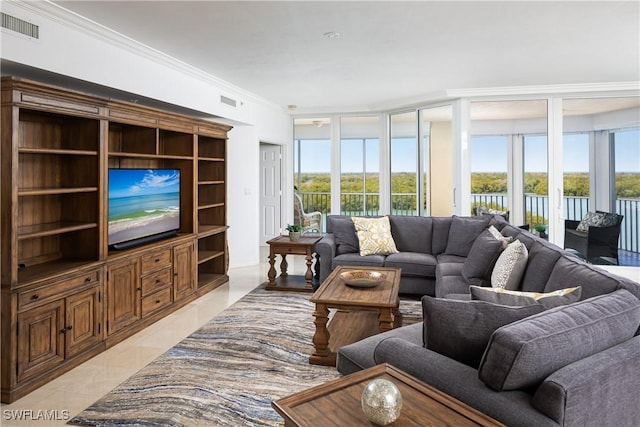 living area featuring visible vents and ornamental molding