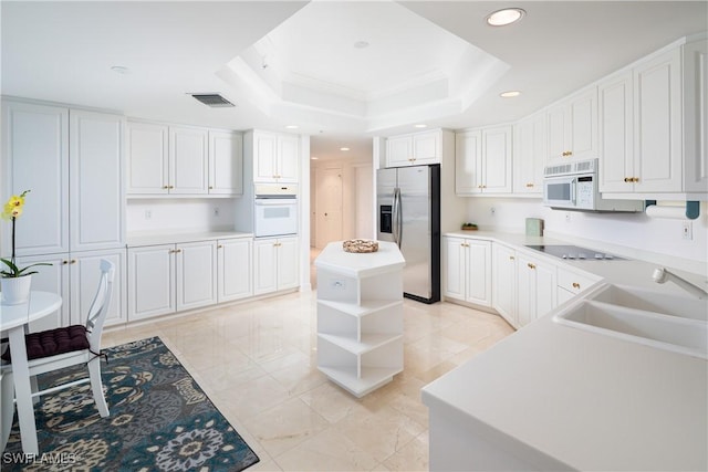 kitchen with a sink, white appliances, open shelves, recessed lighting, and a raised ceiling