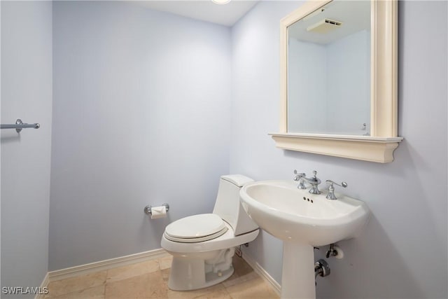 half bathroom featuring toilet and baseboards