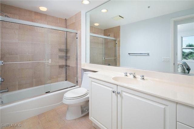 bathroom featuring vanity, toilet, shower / bath combination with glass door, and recessed lighting