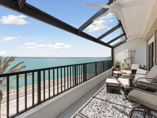 balcony featuring a water view and ceiling fan