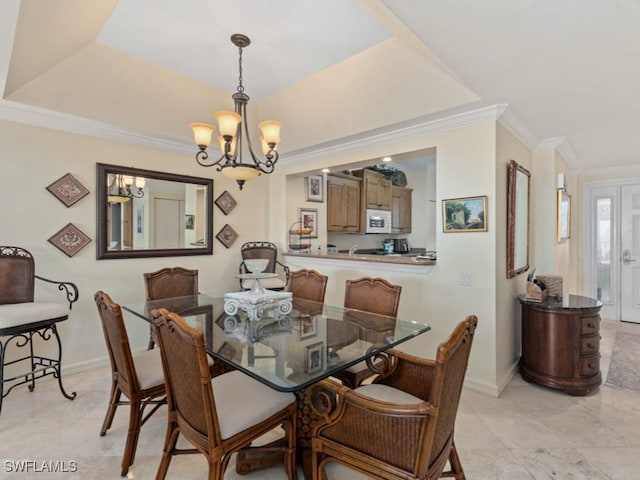 dining room with baseboards, ornamental molding, and a chandelier