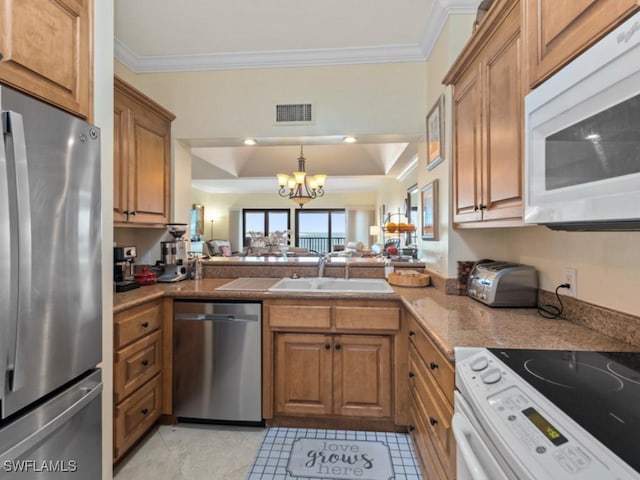 kitchen with brown cabinetry, visible vents, a sink, ornamental molding, and stainless steel appliances