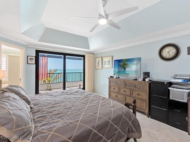 bedroom featuring crown molding, a raised ceiling, multiple windows, and access to exterior
