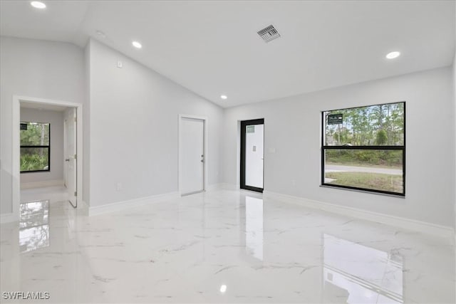 631 Summit Ave S, Lehigh Acres, FL 33974 - unfurnished room featuring vaulted ceiling, recessed lighting, light marble finish floors, and baseboards