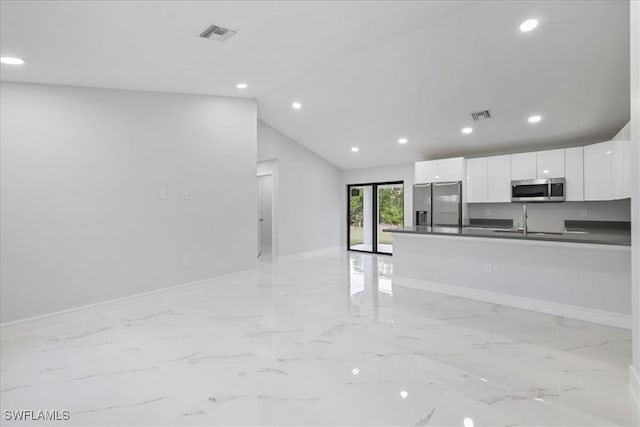 631 Summit Ave S, Lehigh Acres, FL 33974 - kitchen featuring stainless steel appliances, dark countertops, baseboards, white cabinets, and recessed lighting