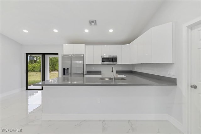 631 Summit Ave S, Lehigh Acres, FL 33974 - kitchen featuring stainless steel appliances, a sink, a peninsula, white cabinetry, and recessed lighting