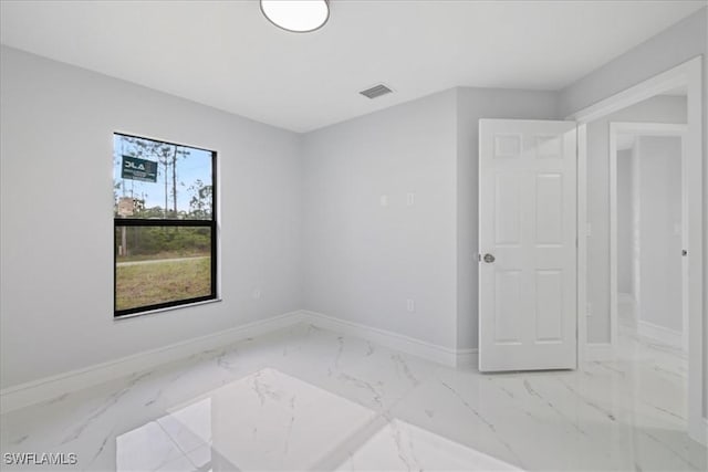 631 Summit Ave S, Lehigh Acres, FL 33974 - spare room featuring marble finish flooring and baseboards