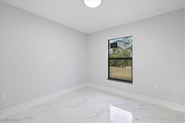 631 Summit Ave S, Lehigh Acres, FL 33974 - unfurnished room with baseboards and marble finish flooring