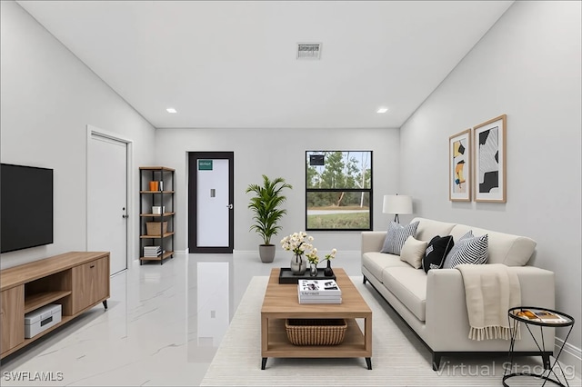 631 Summit Ave S, Lehigh Acres, FL 33974 - living room featuring light marble finish floors, recessed lighting, and baseboards