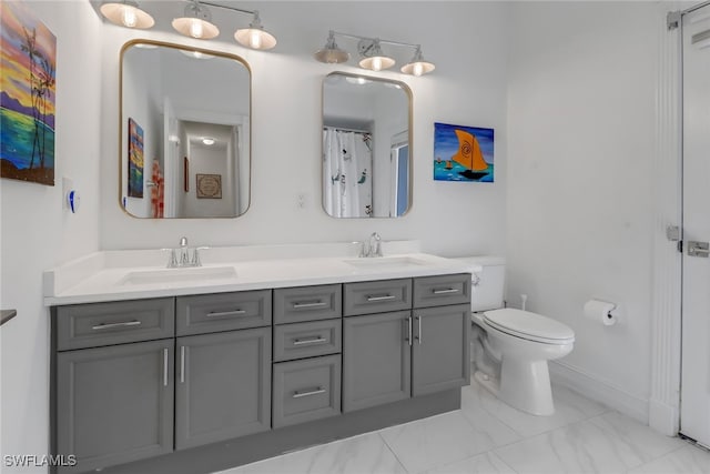 bathroom with a sink, toilet, double vanity, and marble finish floor
