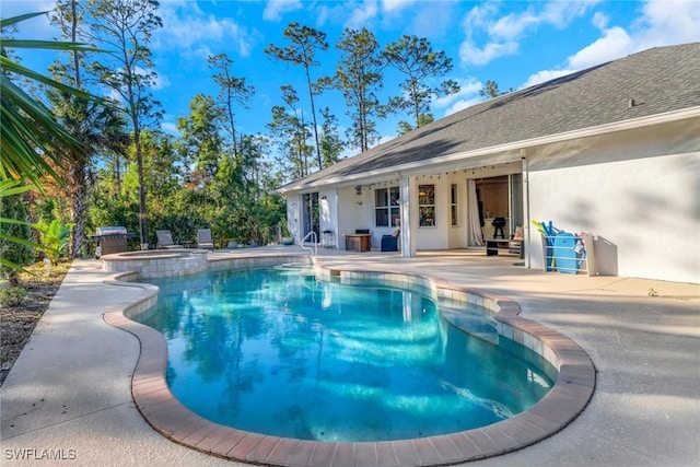 view of pool with a patio and a pool with connected hot tub
