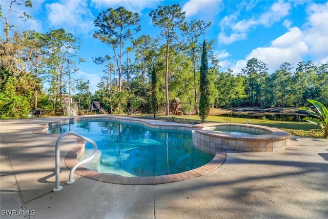 view of pool with a playground and a pool with connected hot tub