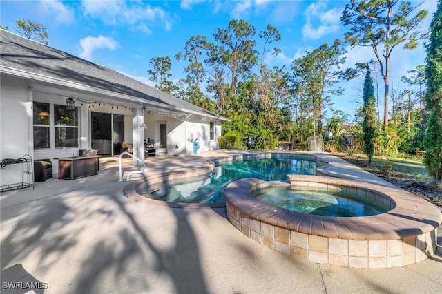 view of pool featuring a pool with connected hot tub and a patio area