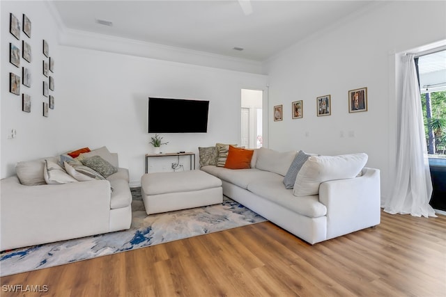 living room featuring crown molding, visible vents, and wood finished floors