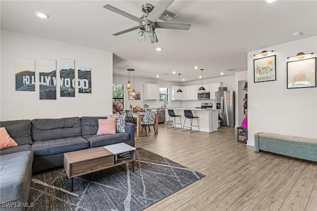 16000 Shoebutton Ct, North Fort Myers, FL 33917 - living area featuring ceiling fan, visible vents, baseboards, light wood finished floors, and recessed lighting