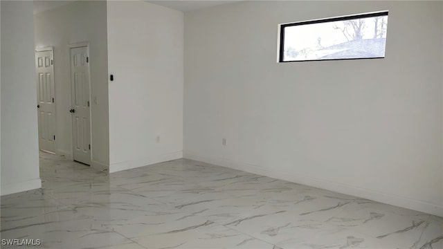 208 Genoa Ave S, Lehigh Acres, FL 33974 - empty room with baseboards and marble finish floor