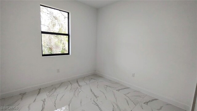 208 Genoa Ave S, Lehigh Acres, FL 33974 - unfurnished room featuring baseboards and marble finish floor