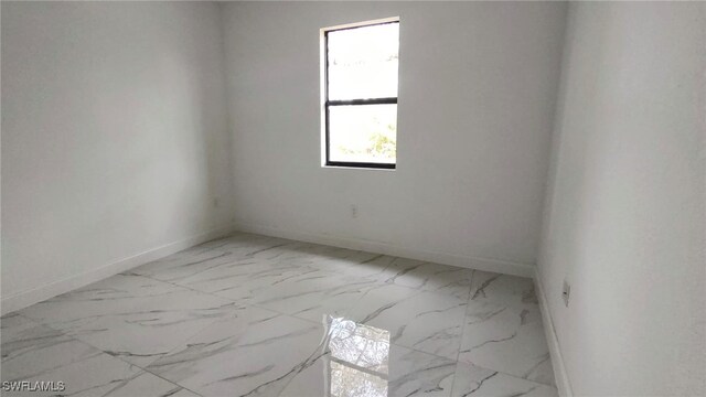 208 Genoa Ave S, Lehigh Acres, FL 33974 - unfurnished room with baseboards and marble finish floor