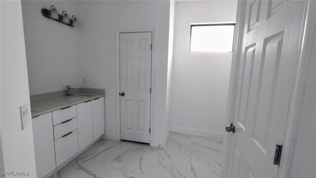 208 Genoa Ave S, Lehigh Acres, FL 33974 - bathroom featuring vanity and marble finish floor