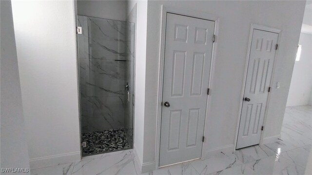 208 Genoa Ave S, Lehigh Acres, FL 33974 - full bathroom with baseboards, marble finish floor, and a marble finish shower