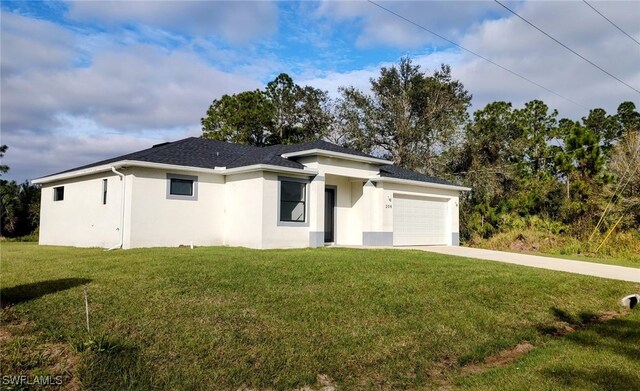 208 Genoa Ave S, Lehigh Acres, FL 33974 - prairie-style home with a garage, stucco siding, concrete driveway, and a front lawn
