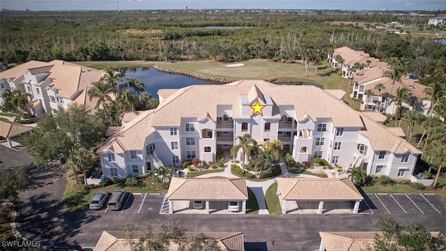 aerial view featuring view of golf course and a water view