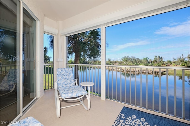 sunroom with a water view and a wealth of natural light
