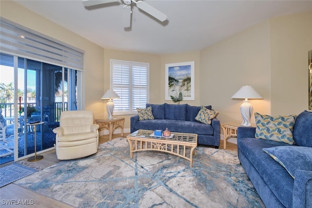 living area with a ceiling fan and a wealth of natural light