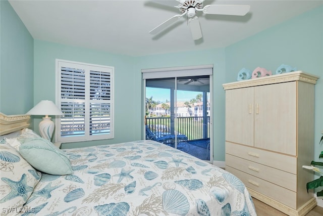 bedroom with baseboards, a ceiling fan, wood finished floors, and access to exterior