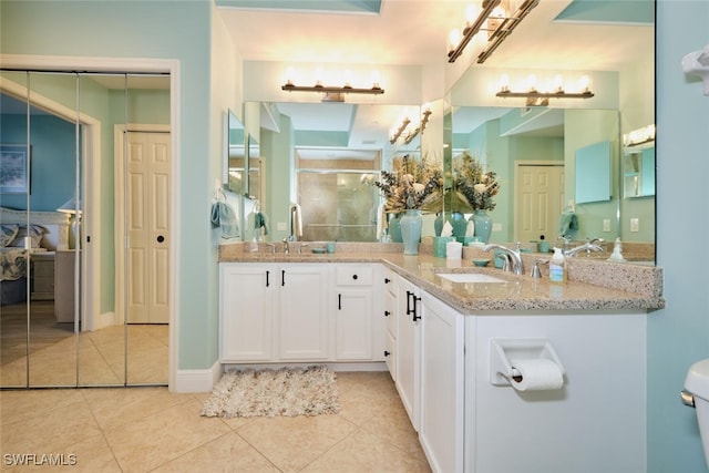 bathroom with a sink, tile patterned flooring, and a stall shower