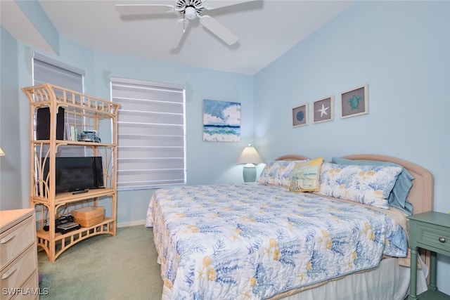 carpeted bedroom featuring baseboards and a ceiling fan