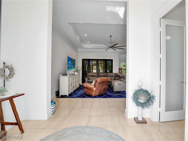 interior space with baseboards, recessed lighting, a tray ceiling, and ceiling fan