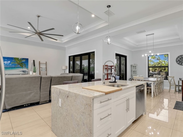 kitchen with visible vents, dishwasher, a sink, light tile patterned floors, and a tray ceiling