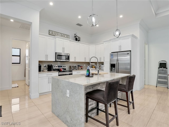 kitchen featuring visible vents, tasteful backsplash, a sink, appliances with stainless steel finishes, and light tile patterned floors
