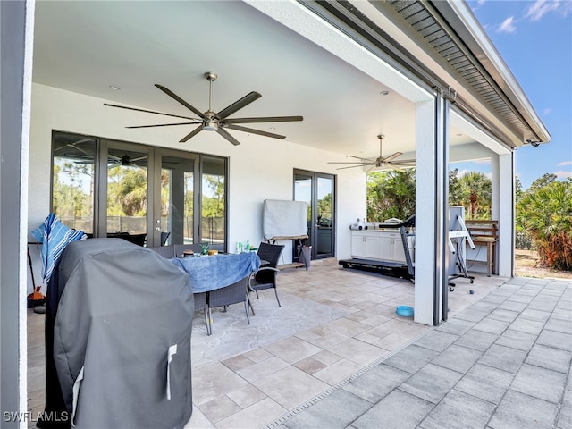 view of patio featuring french doors, a ceiling fan, outdoor dining space, and a grill