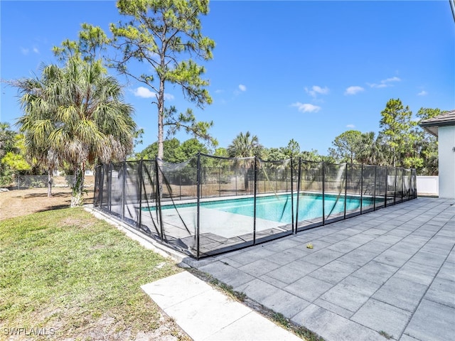 view of pool featuring fence, a fenced in pool, and a lawn