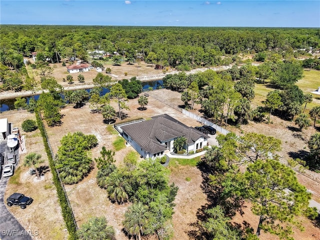 drone / aerial view featuring a wooded view