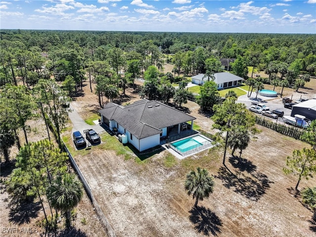 birds eye view of property with a view of trees