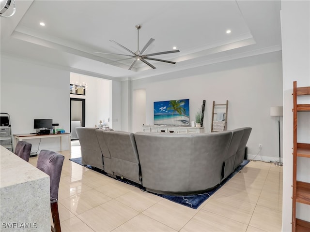living area featuring ornamental molding, recessed lighting, a raised ceiling, ceiling fan with notable chandelier, and light tile patterned floors